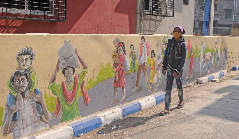 A girl walks past a wall Graffiti