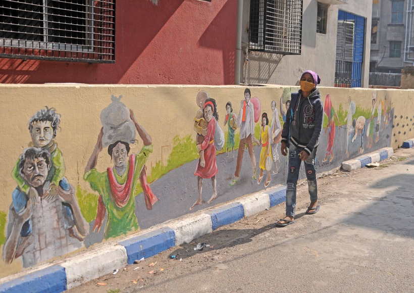 A girl walks past a wall Graffiti