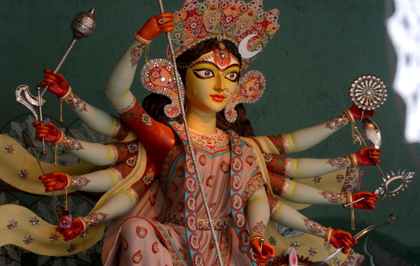 People visit the idol of Goddess Durga at a community puja pandal