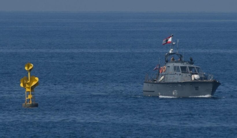 A Lebanese navy patrol boat is stationed next to a buoy marking the maritime border between Lebanon and Israel in the Mediterranean sea waters off Lebanon's southern Naqoura near Rosh HaNikra in northern Israel on Oct. 27, 2022