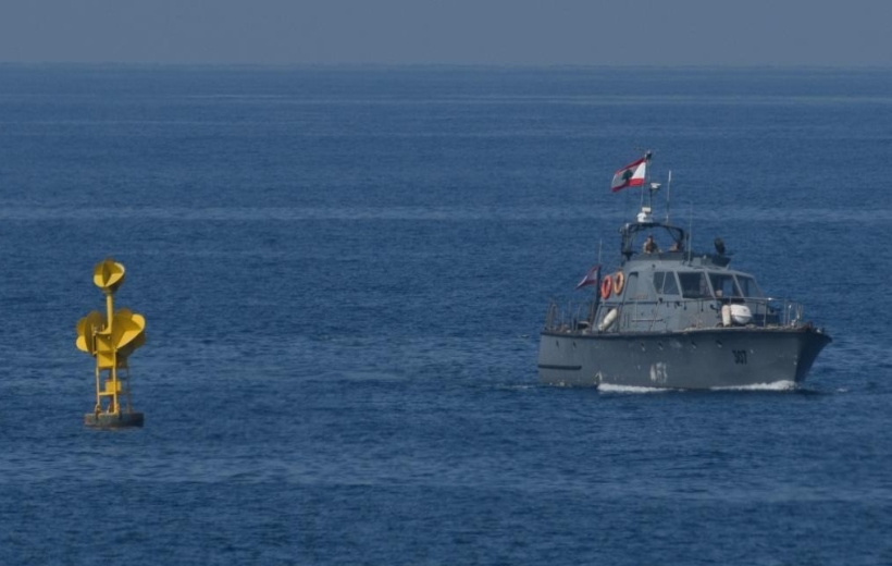 A Lebanese navy patrol boat is stationed next to a buoy marking the maritime border between Lebanon and Israel in the Mediterranean sea waters off Lebanon's southern Naqoura near Rosh HaNikra in northern Israel on Oct. 27, 2022