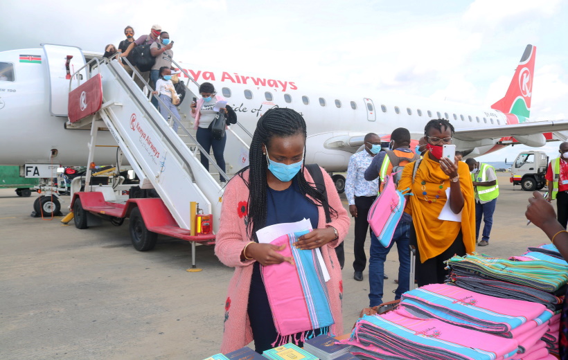 Passengers disembark from a Kenya Airways plane at Moi International Airport in Mombasa, Kenya,