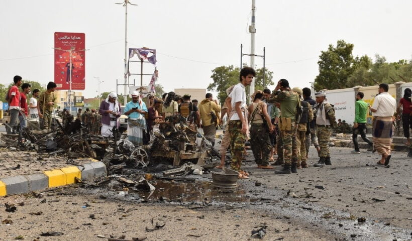Security forces inspect the site where a motorcade of a Yemeni military official was attacked by a car bomb in Aden, southern Yemen,