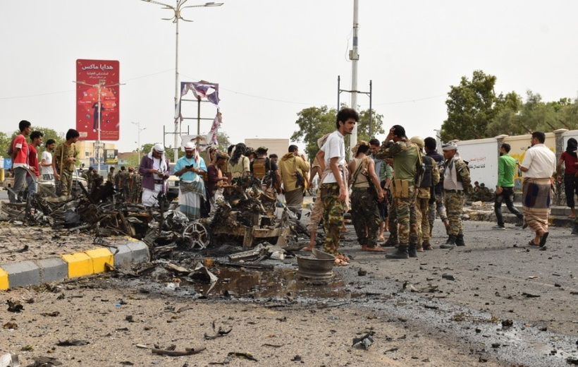 Security forces inspect the site where a motorcade of a Yemeni military official was attacked by a car bomb in Aden, southern Yemen,