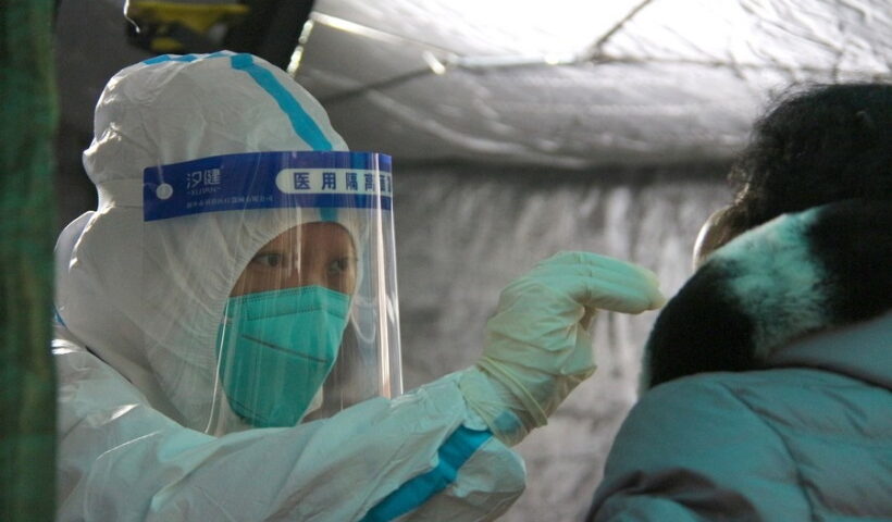 A medical worker takes a swab sample from a resident for nucleic acid test at a COVID-19 testing site in Fengtai District in Beijing. (Xinhua/Tang Rufeng/IANS)