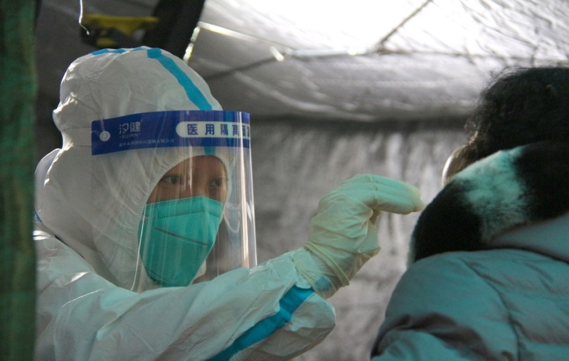 A medical worker takes a swab sample from a resident for nucleic acid test at a COVID-19 testing site in Fengtai District in Beijing. (Xinhua/Tang Rufeng/IANS)