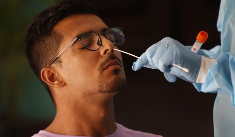 New Delhi: A health worker collects a nasal sample from a man for the RT-PCR test of Covid-19 at the hostel of Indira Gandhi Indoor stadium in New Delhi