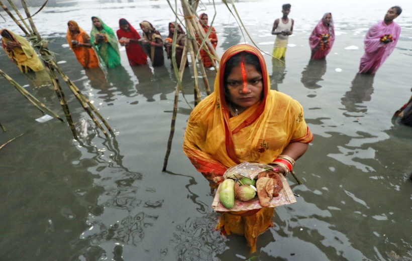 Delhi: Devotees perform rituals in the Yamuna river, covered by chemical foam caused due to industrial and domestic pollution