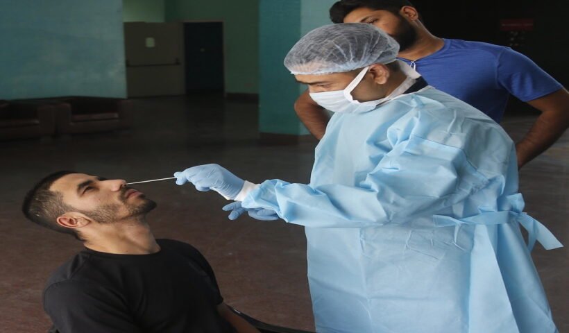 A health worker collects a nasal sample from a man for the RT-PCR test of Covid-19 at the hostel of Indira Gandhi Indoor stadium in New Delhi on Thursday, May 05, 2022. (Photo: Qamar Sibtain/IANS)