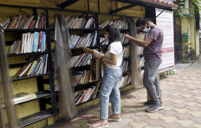 People reading books at a street library in Kolkata