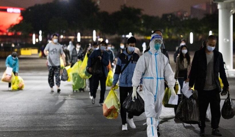 A medical worker leads recovered COVID-19