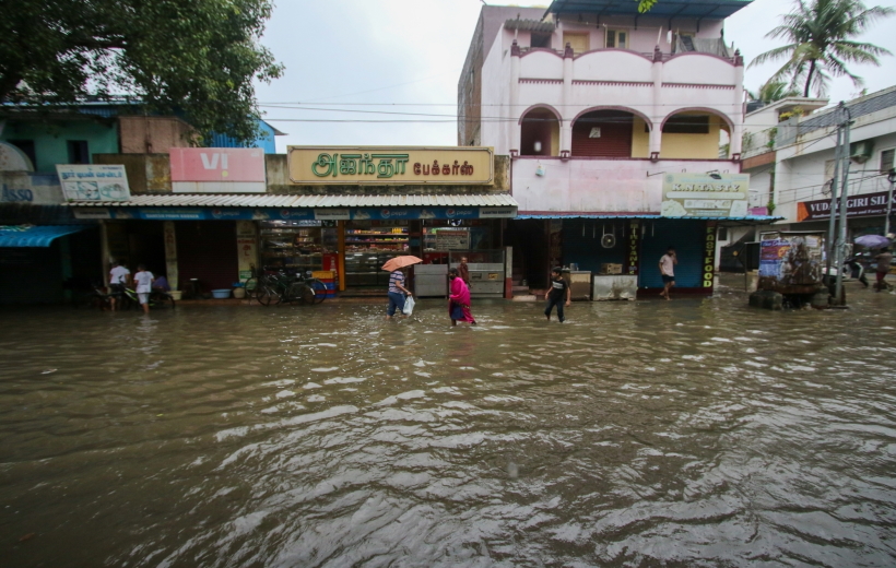 Chennai: People wade through a waterlogged road after heavy rain, in Chennai on Friday, Nov.