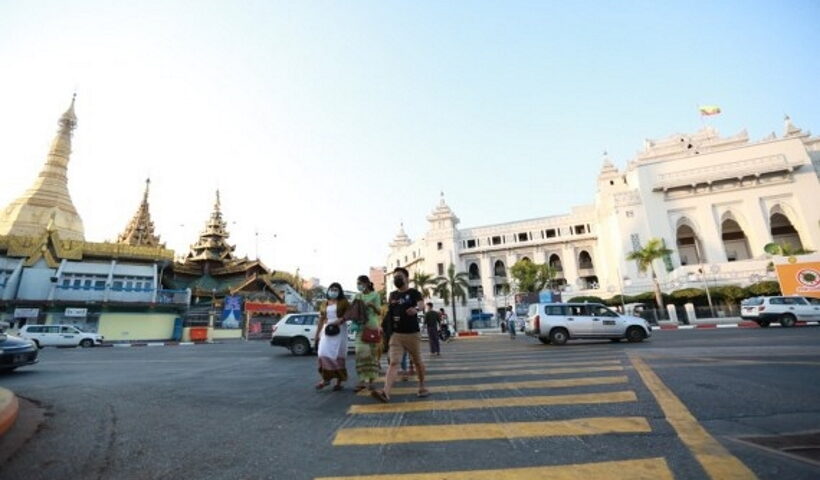 Pedestrians cross a road next to the city hall of Yangon, Myanmar, Feb. 3, 2021. (Xinhua/Zhang Dongqiang/ians)