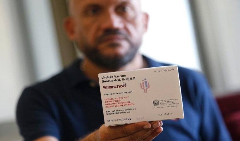 man displays a box of cholera vaccines during a press conference held at the Ministry of Public Health in Beirut, Lebanon,