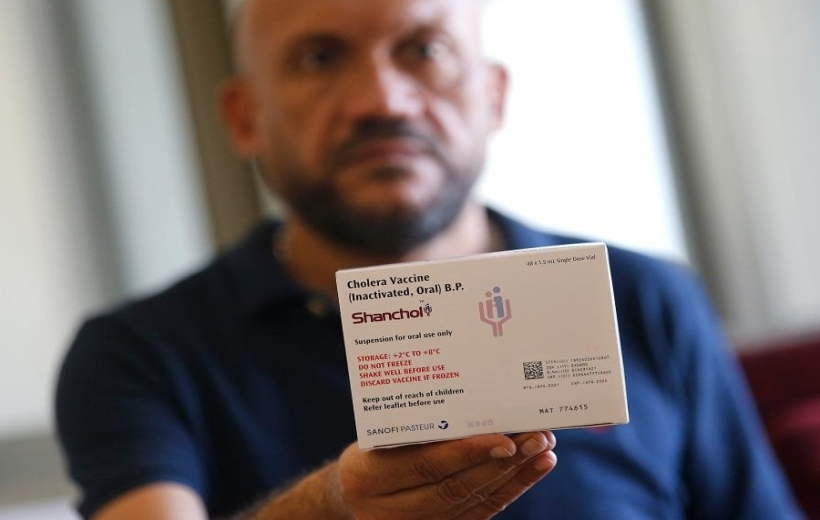 man displays a box of cholera vaccines during a press conference held at the Ministry of Public Health in Beirut, Lebanon,