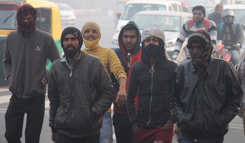 New Delhi:Labourers wrap with warm cloth amid a cold and winter foggy morning in New Delhi