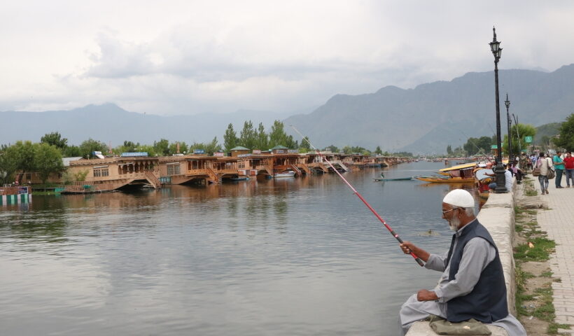 Srinagar: A man enjoys fishing at the Dal Lake, in Srinagar on June 19, 2019.