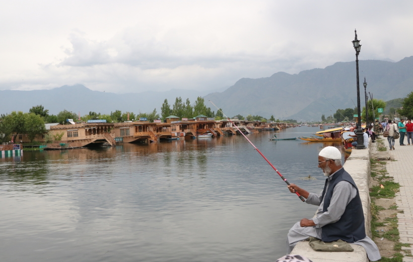 Srinagar: A man enjoys fishing at the Dal Lake, in Srinagar on June 19, 2019.