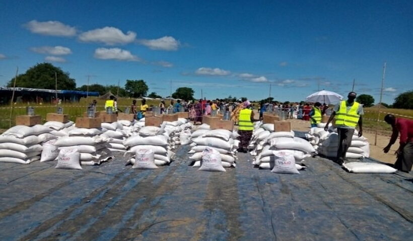 Officials distribute food items provided by the United Nations humanitarian agencies to the affected people in Jonglei State, South Sudan,