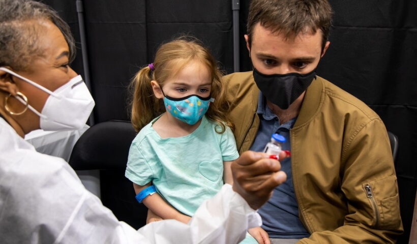 A healthcare worker shows a vial of the COVID-19 vaccine at a vaccination site in Times Square, New York, the United States,