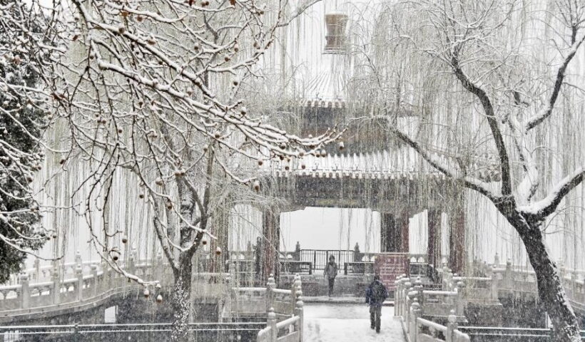 A citizen rides in snow in Beijing, capital of China