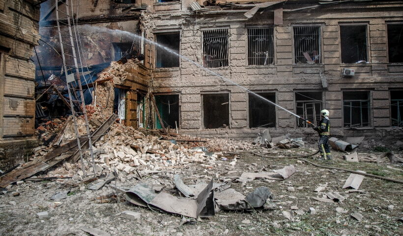 26 August 2022, Ukraine, Slovyansk: A rescue worker extinguishes a fire caused by an overnight shelling at the Slovyansk Chemical Mechanical College