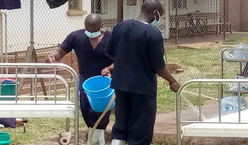 edical workers perform disinfection for a demarcated Ebola treatment center at the Mubende