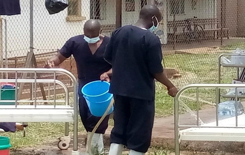 edical workers perform disinfection for a demarcated Ebola treatment center at the Mubende