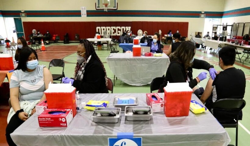 Health workers administer COVID-19 vaccine shots to local residents in Los Angeles, the United States