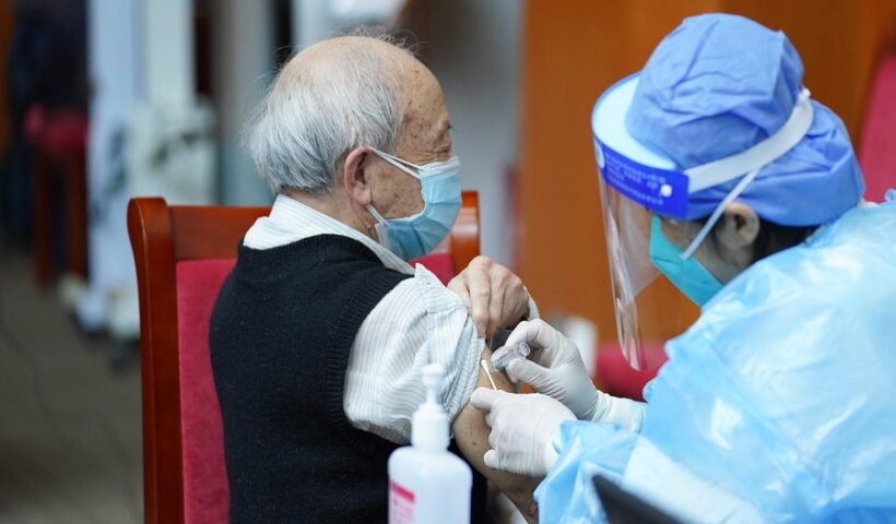 A medical worker injects COVID-19 vaccine for a senior citizen in Dongcheng District of Beijing, capital of China,