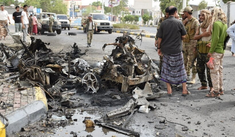 Security forces inspect the site where a motorcade of a Yemeni military official was attacked by a car bomb in Aden,