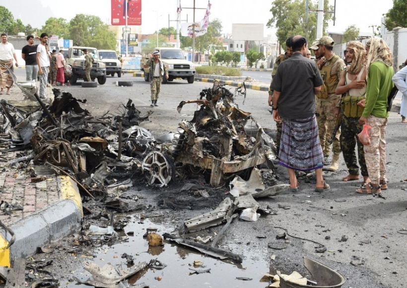 Security forces inspect the site where a motorcade of a Yemeni military official was attacked by a car bomb in Aden,