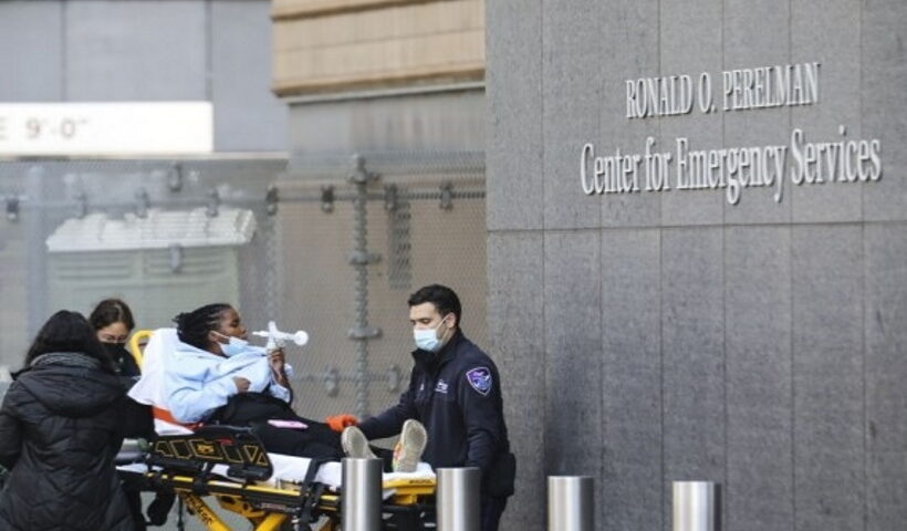 A healthcare worker watches a patient in the "COVID Area" of the Beverly Hospital in Montebello City,