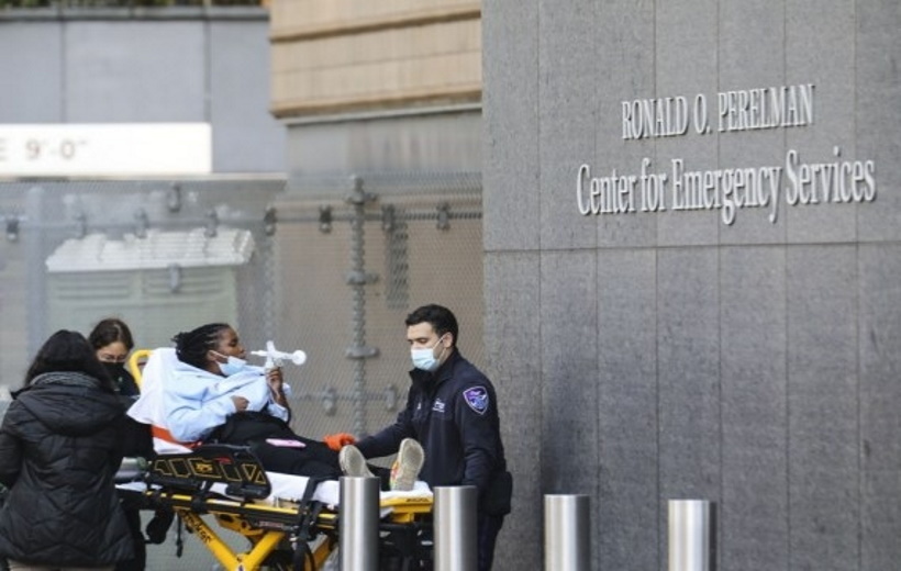 A healthcare worker watches a patient in the "COVID Area" of the Beverly Hospital in Montebello City,
