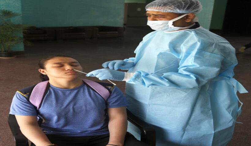 New Delhi: A health worker collects a nasal sample from a sports woman for the RT-PCR test of Covid-19 at the hostel of Indira Gandhi Indoor stadium in New Delhi