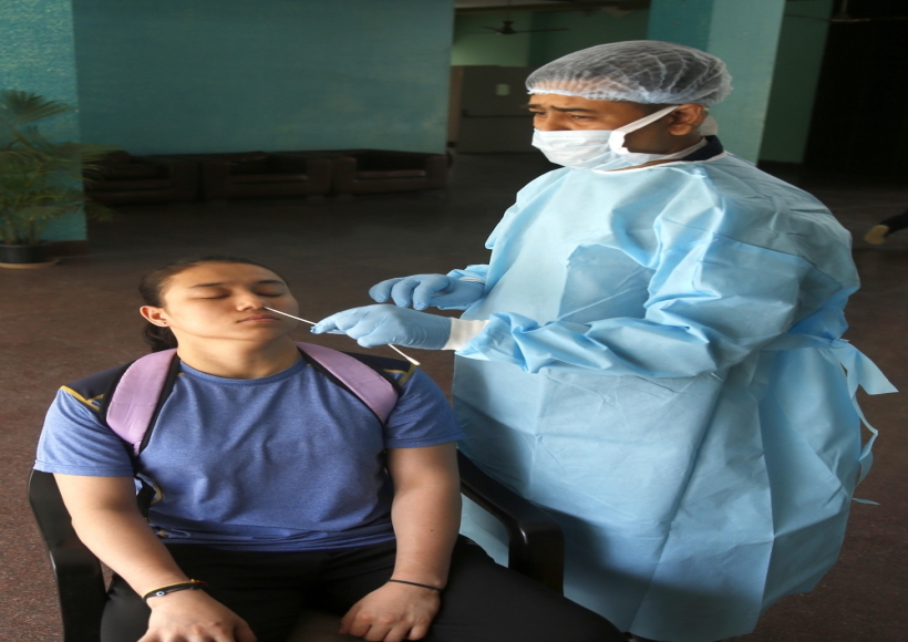 New Delhi: A health worker collects a nasal sample from a sports woman for the RT-PCR test of Covid-19 at the hostel of Indira Gandhi Indoor stadium in New Delhi