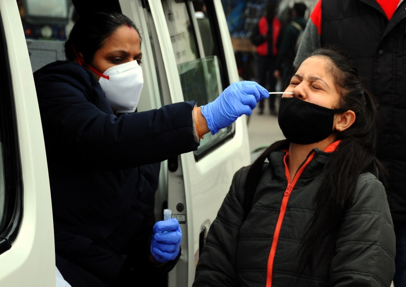 New Delhi:A health worker conduct random COVID-19 testing at Seelampur area as Coronavirus cases rise across the country in New Delhi