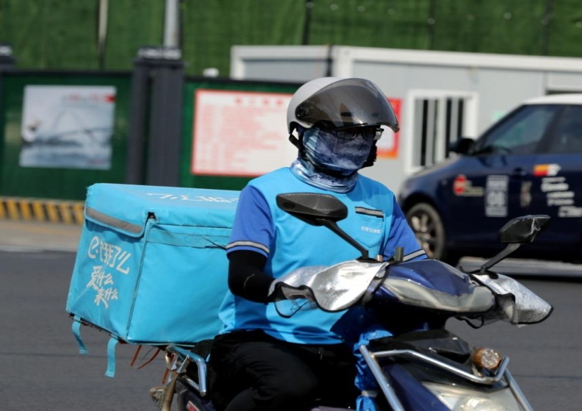 A deliveryman is seen on the street amid high temperature in Minhang District of east China's