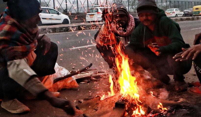 New Delhi: People keep themself warm by sitting around a bonfire on a cold day in the early morning in New Delhi on Friday,