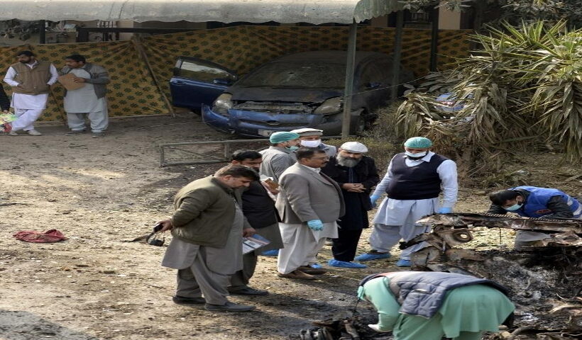 Security personnel investigate at the site of a suicide attack in Pakistan's capital Islamabad