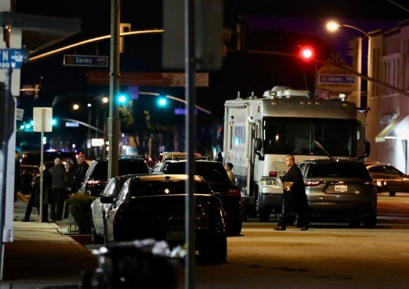 Police officers stand guard on the scene of a mass shooting in Monterey Park, California, the United States