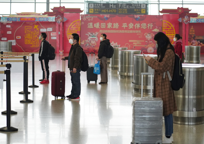 Passengers line up at a certain distance before checking-in at the Terminal 3 of Xianyang International Airport in Xi'an, northwest China's Shaanxi Province, Feb. 12, 2020. People are encouraged to line up with a distance of at least one meter with each other in recent days as a measure to prevent and control the epidemic