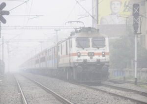 Patna: A train makes its way amid low visibility due to a dense fog in Patna