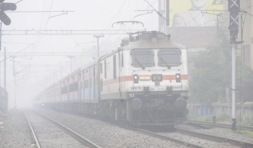 Patna: A train makes its way amid low visibility due to a dense fog in Patna