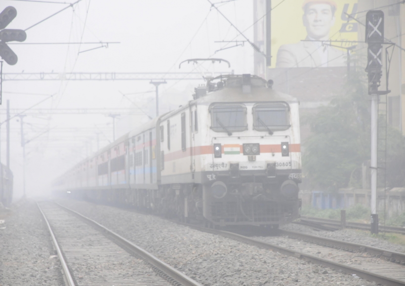 Patna: A train makes its way amid low visibility due to a dense fog in Patna