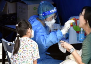 A citizen takes COVID-19 nucleic acid test at a mobile nucleic acid testing site in Hong Kong, south China