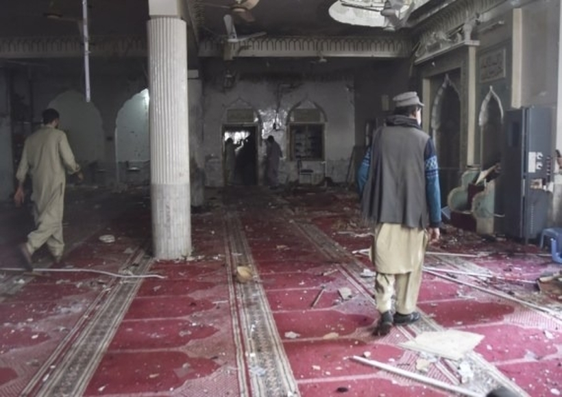 Rescuers inspect damaged area of a mosque following a blast in Peshawar, Pakistan, on March