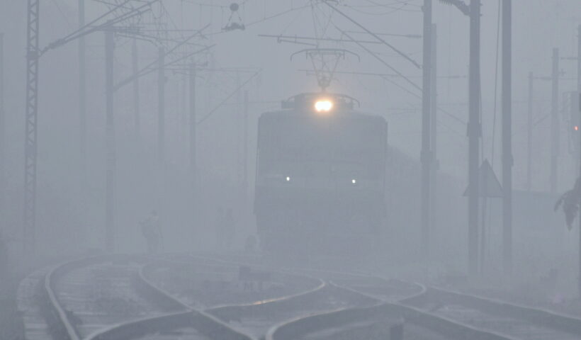 New Delhi: A train runs on a railway track amid dense fog on a cold day, in New Delhi on Monday