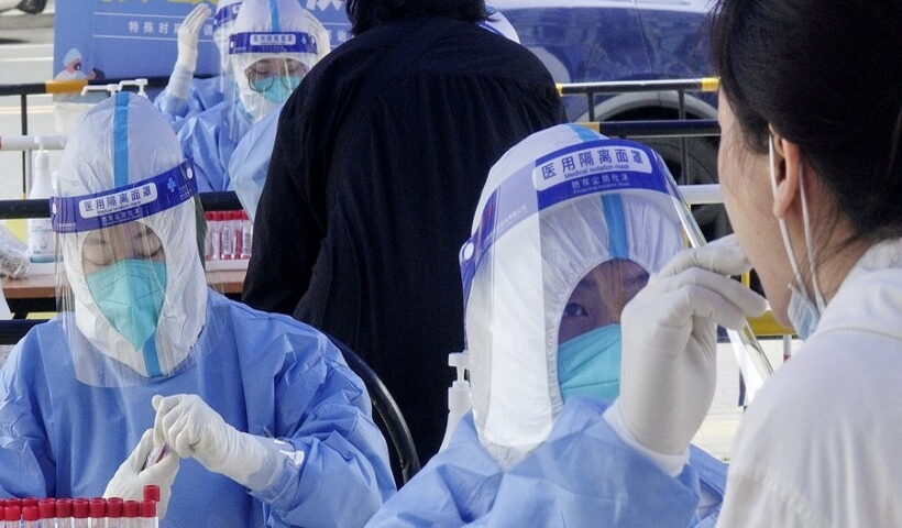 A medic takes swab samples from a resident for nucleic acid testing at Balizhuang subdistrict in Chaoyang District, Beijing, capital of China,