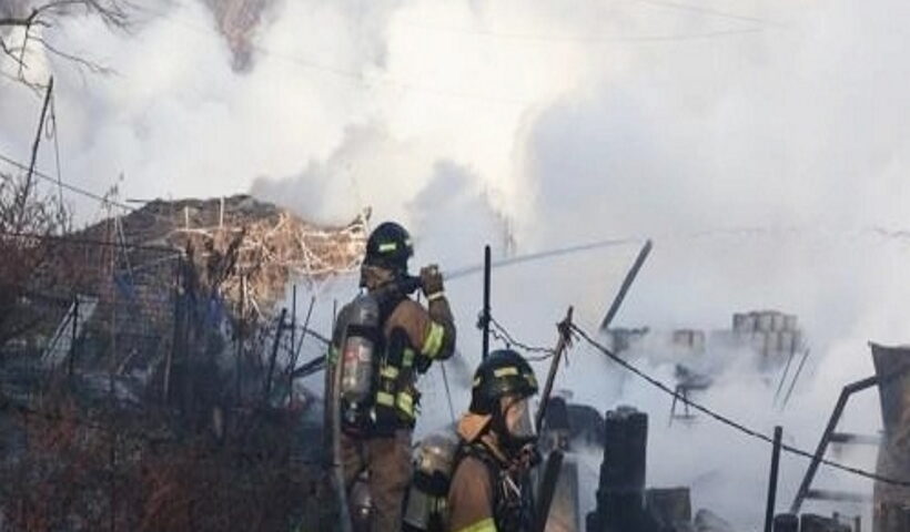 Firefighters battle a fire in the fourth district of Guryong Village, the last remaining slum in Seoul, in the capital's Gangnam Ward